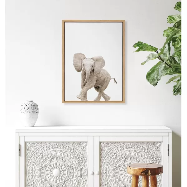 Kate and Laurel Sylvie Baby Elephant Walk Framed Canvas Wall Art by Amy Peterson Art Studio 18x24 Natural Modern Animal Portrait Art for WallNatural