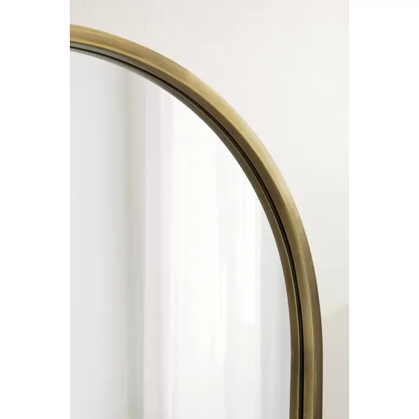 imageKate and Laurel Rowla Modern Arched Wall Mirror 24 x 32 Gold Decorative Glam Arch Mirror with Luxurious Polished Antique Brass Finish and Versatile StylingGold