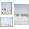 imageKate and Laurel Sylvie Waves Crashing Palm Tree Paradise and Pale Blue Lifeguard Tower Framed Canvas Wall Art Set by Caroline Mint Set of 3 two 16x20 and one 23x33 White Coastal Calming Wall Decor For Your Living Room or Bedroom