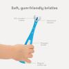 imageFrida Baby TripleAngle Toothhugger Training Toddler Toothbrush  Toddler Toothbrush 2 Years and Up Cleans All Sides at Once  YellowBlue